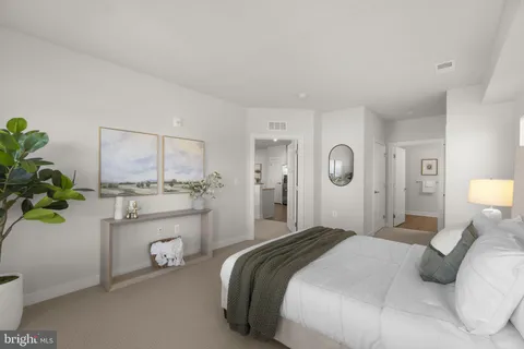 a bedroom with a bed potted plant and a window