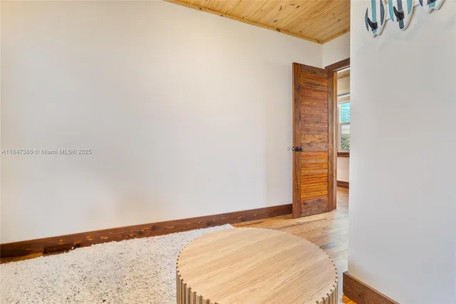 a bedroom with a large bed and a large window