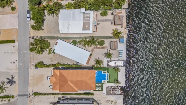 a view of gallery with large windows and furniture