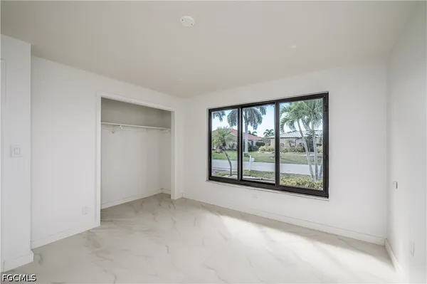an empty room with windows and closet