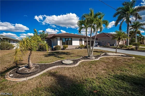 a house with palm tree in front of it