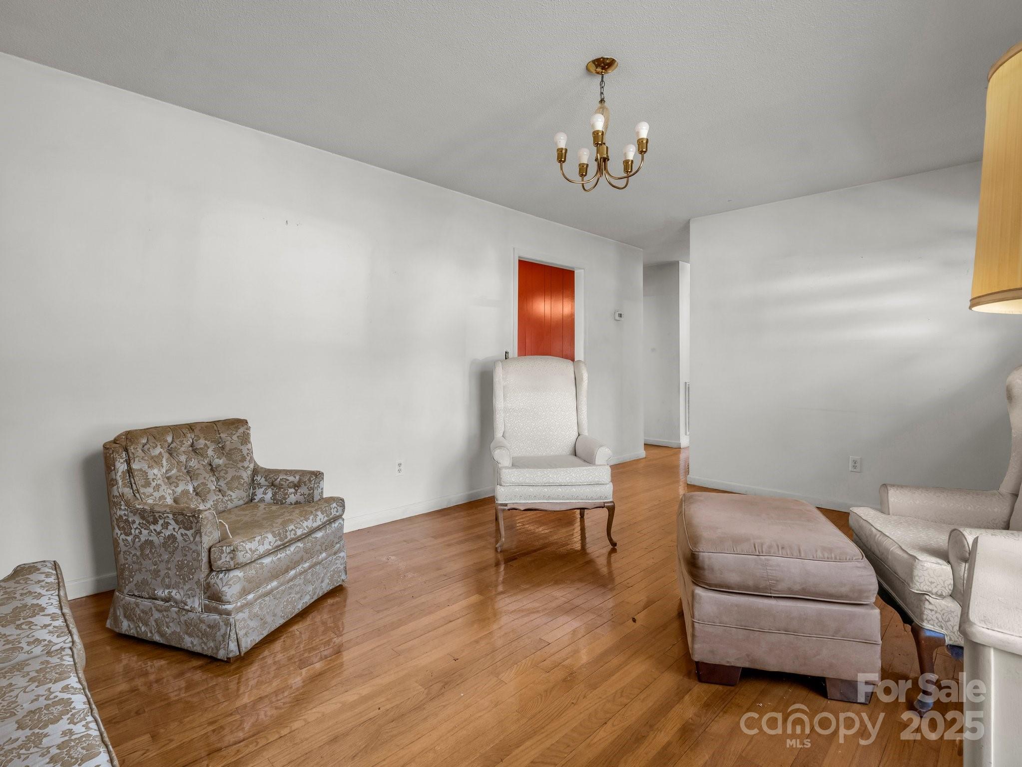 127 Mapp Street Spindale, NC 28160 - Photo 12 of 32 a living room with furniture and a chandelier