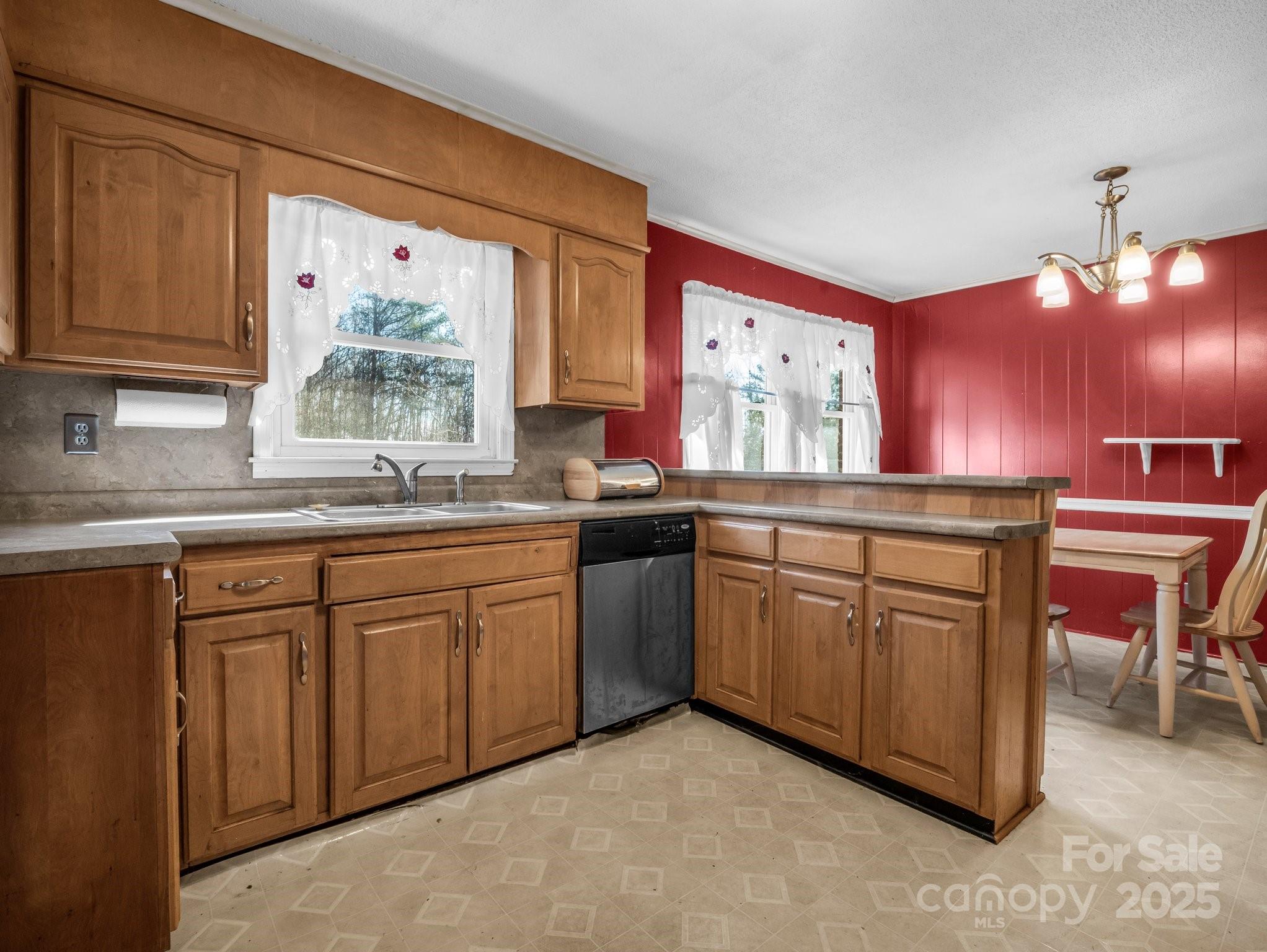 127 Mapp Street Spindale, NC 28160 - Photo 17 of 32 a kitchen with granite countertop a sink cabinets stainless steel appliances and a window