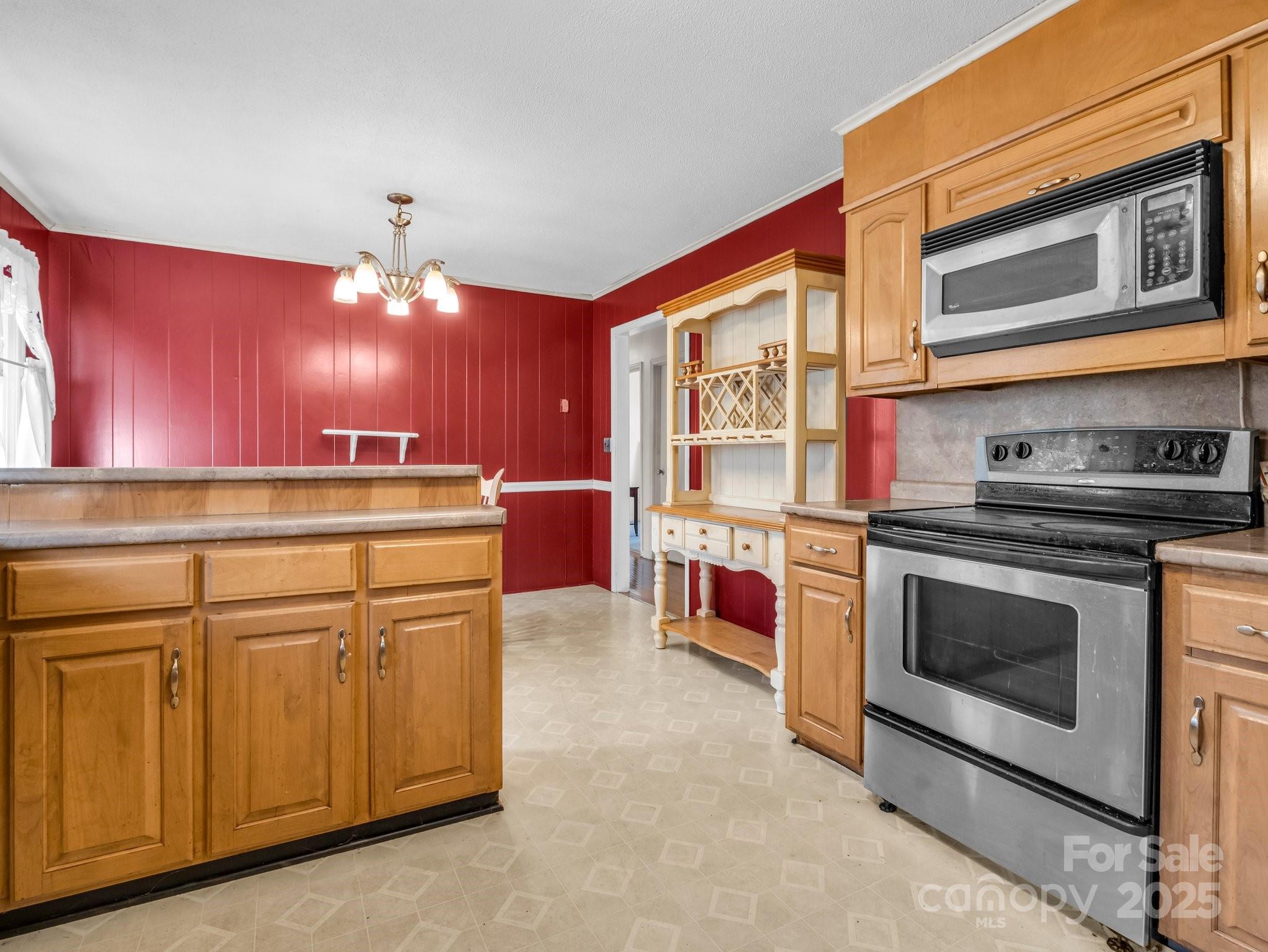 127 Mapp Street Spindale, NC 28160 - Photo 18 of 32 a kitchen with stainless steel appliances granite countertop a stove and a microwave