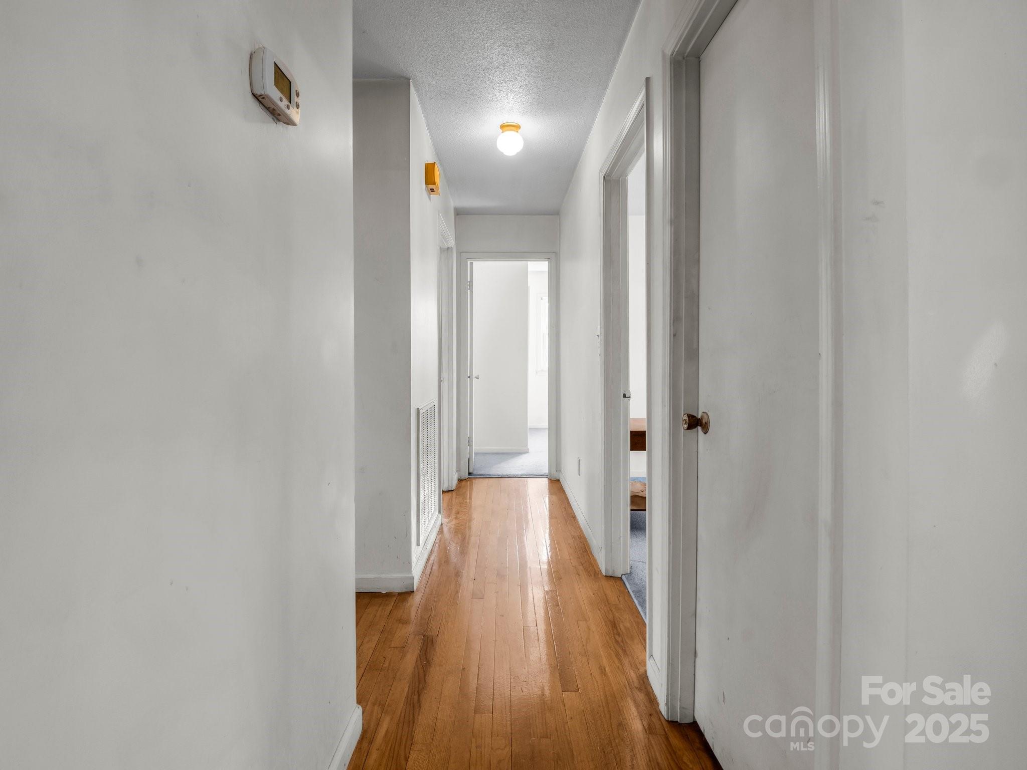 127 Mapp Street Spindale, NC 28160 - Photo 22 of 32 a view of a hallway with wooden floor and closet