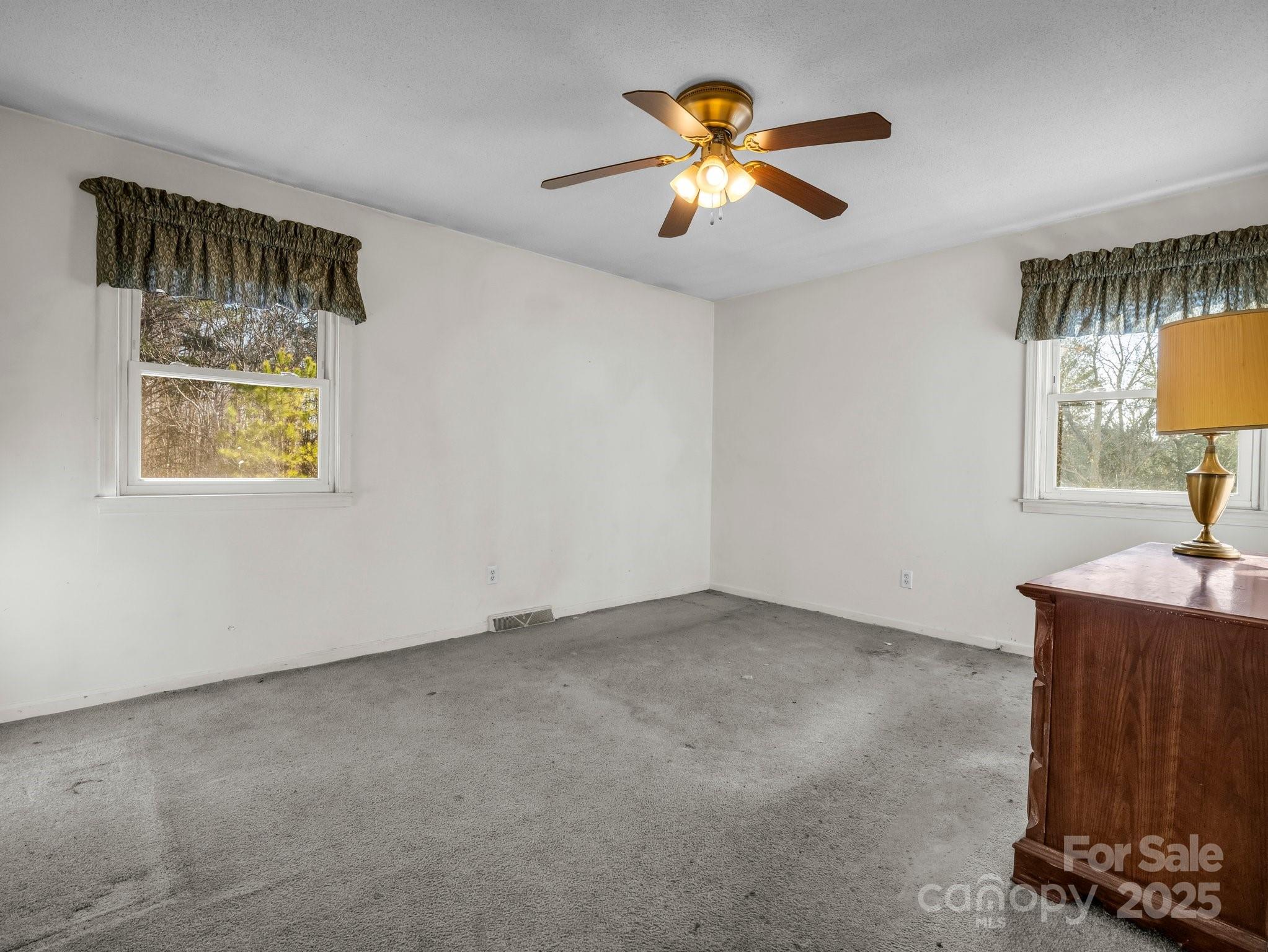 127 Mapp Street Spindale, NC 28160 - Photo 23 of 32 an empty room with a window and a chandelier fan