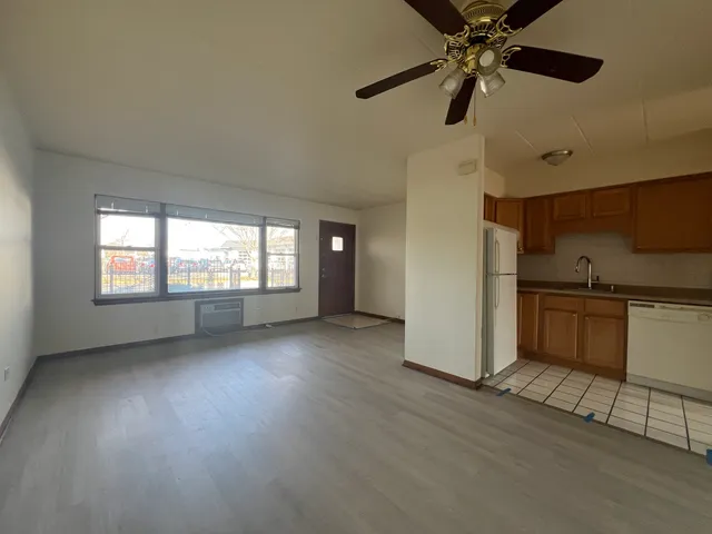 a view of a kitchen and window in the room