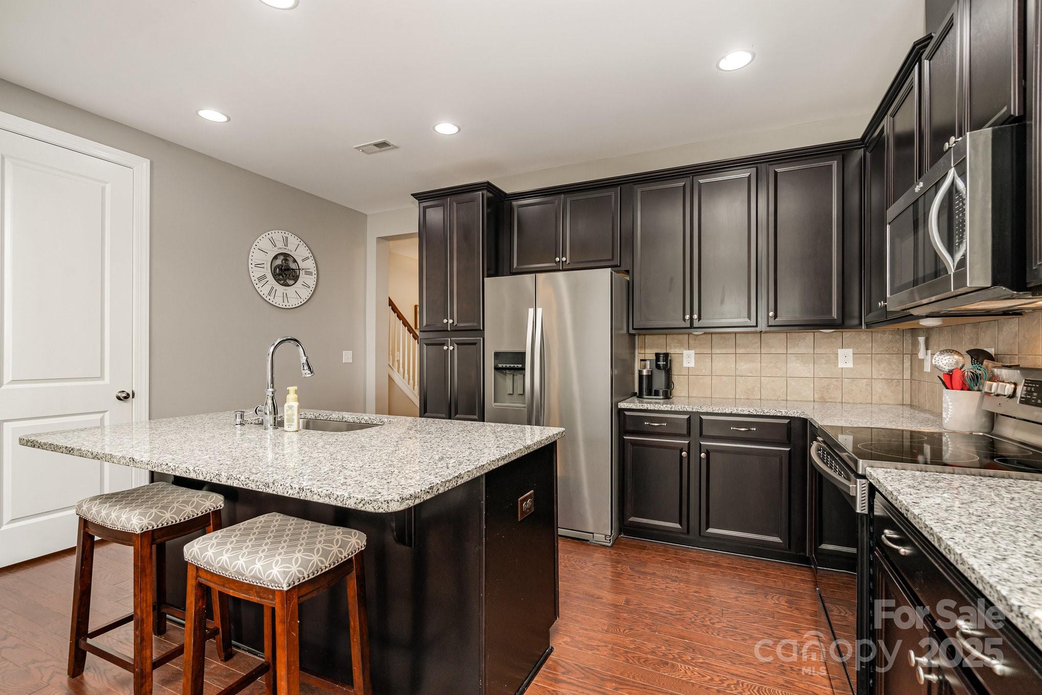 1005 Archibald Avenue Fort Mill, SC 29708 - Photo 13 of 42 a kitchen with granite countertop a sink cabinets stainless steel appliances and a center island
