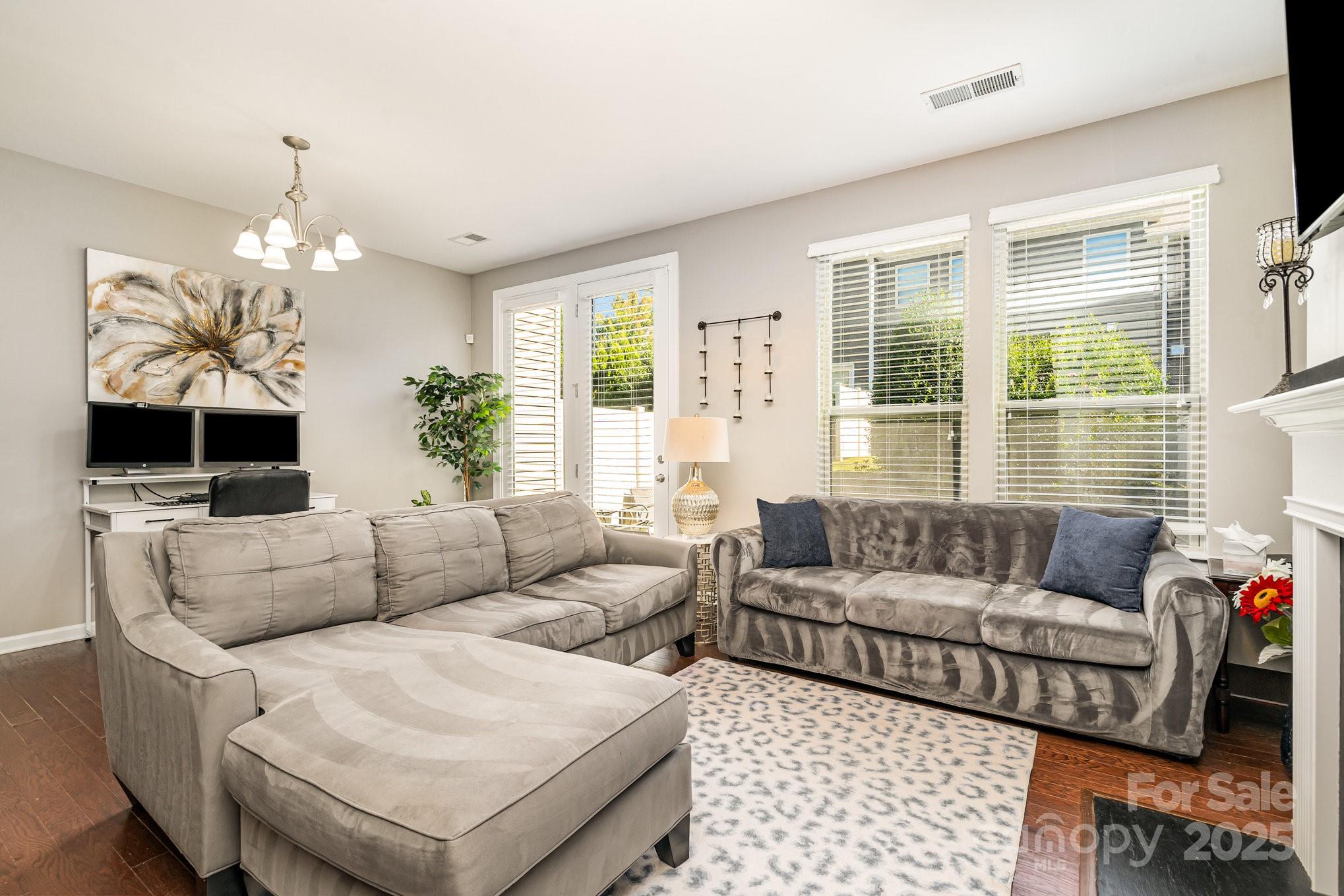 1005 Archibald Avenue Fort Mill, SC 29708 - Photo 18 of 42 a living room with furniture a large window and a chandelier