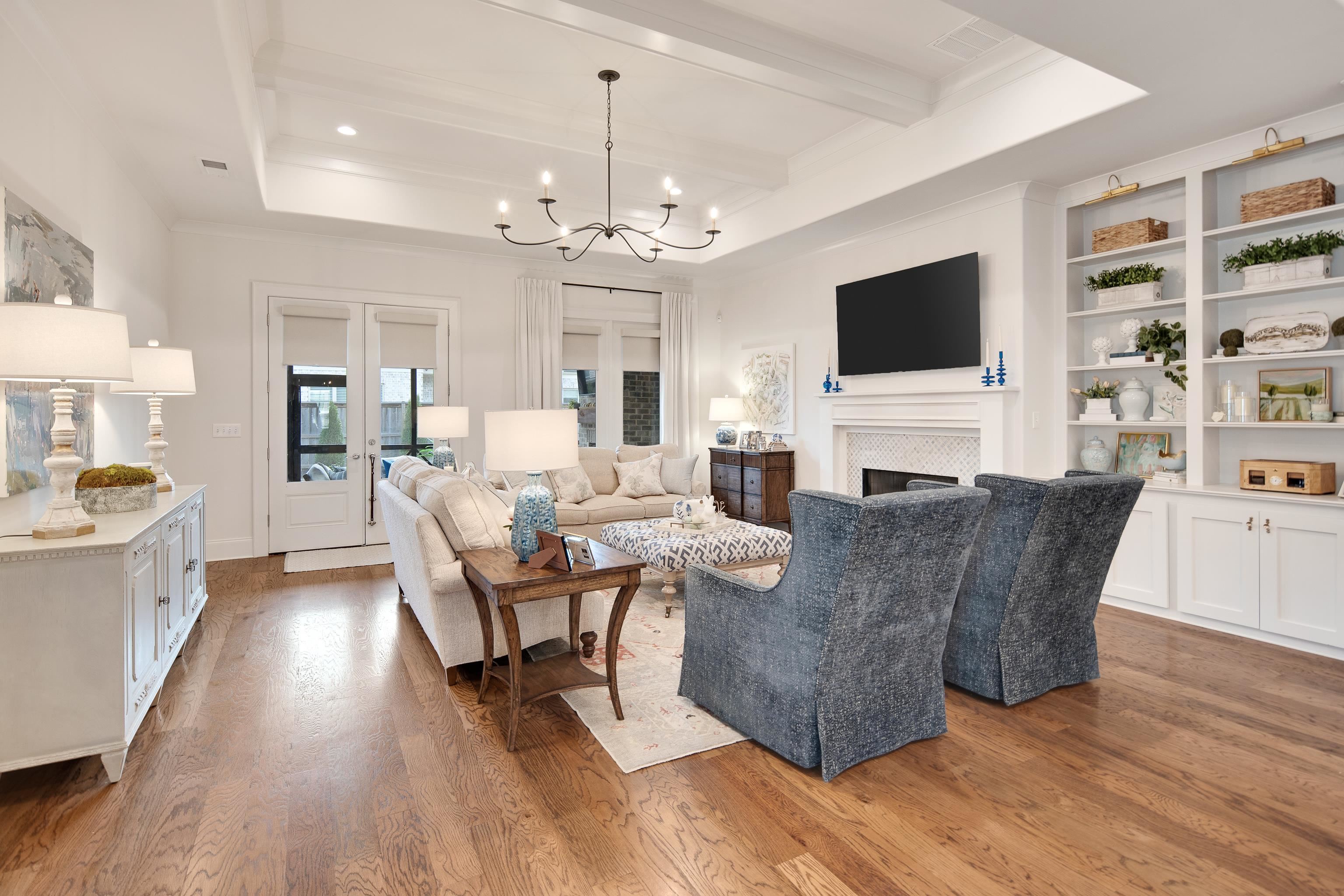 1389 Peyton Parkway Collierville, TN 38017 - Photo 12 of 38 a living room with furniture a flat screen tv and kitchen view