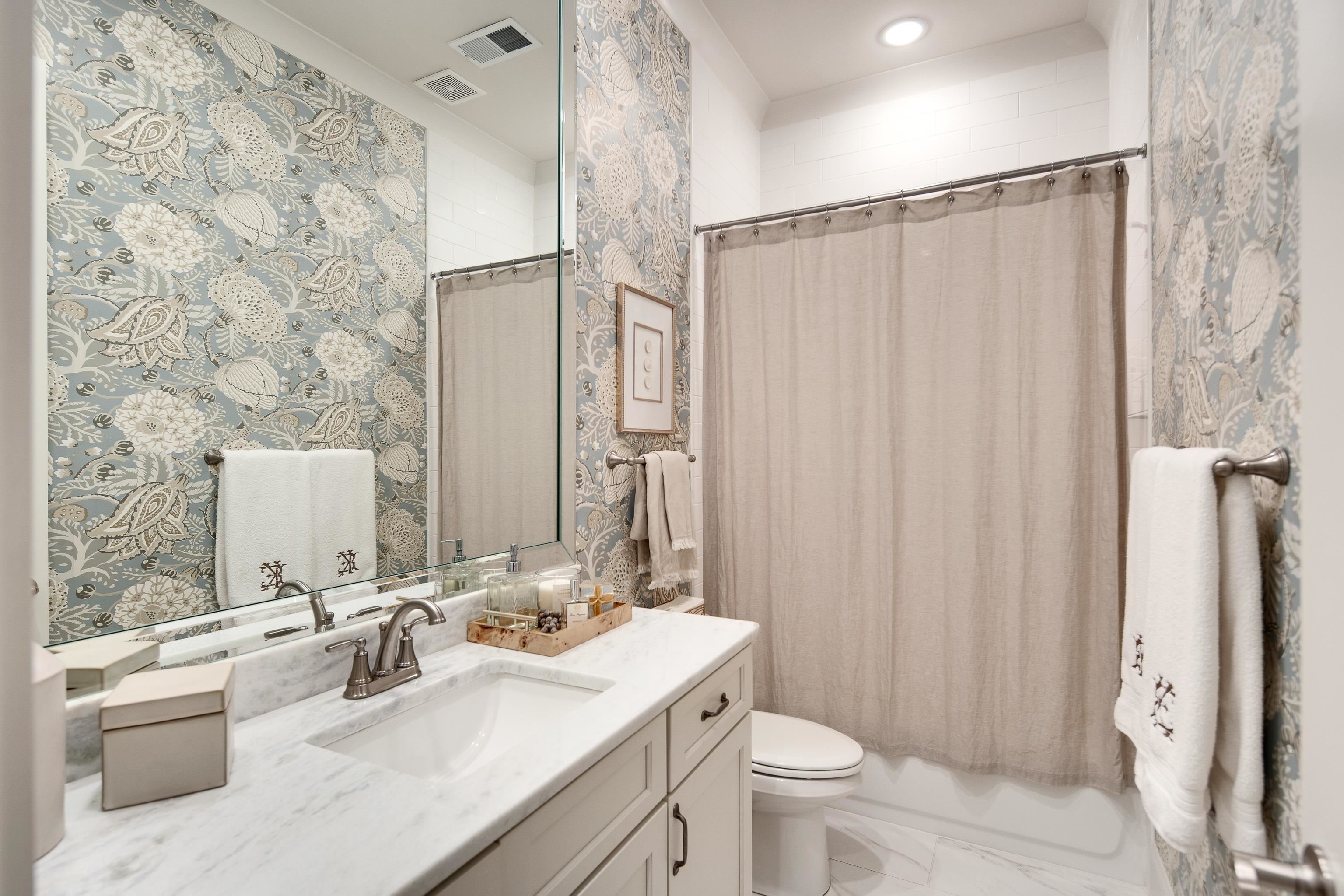 1389 Peyton Parkway Collierville, TN 38017 - Photo 23 of 38 a bathroom with a sink a toilet and shower curtain