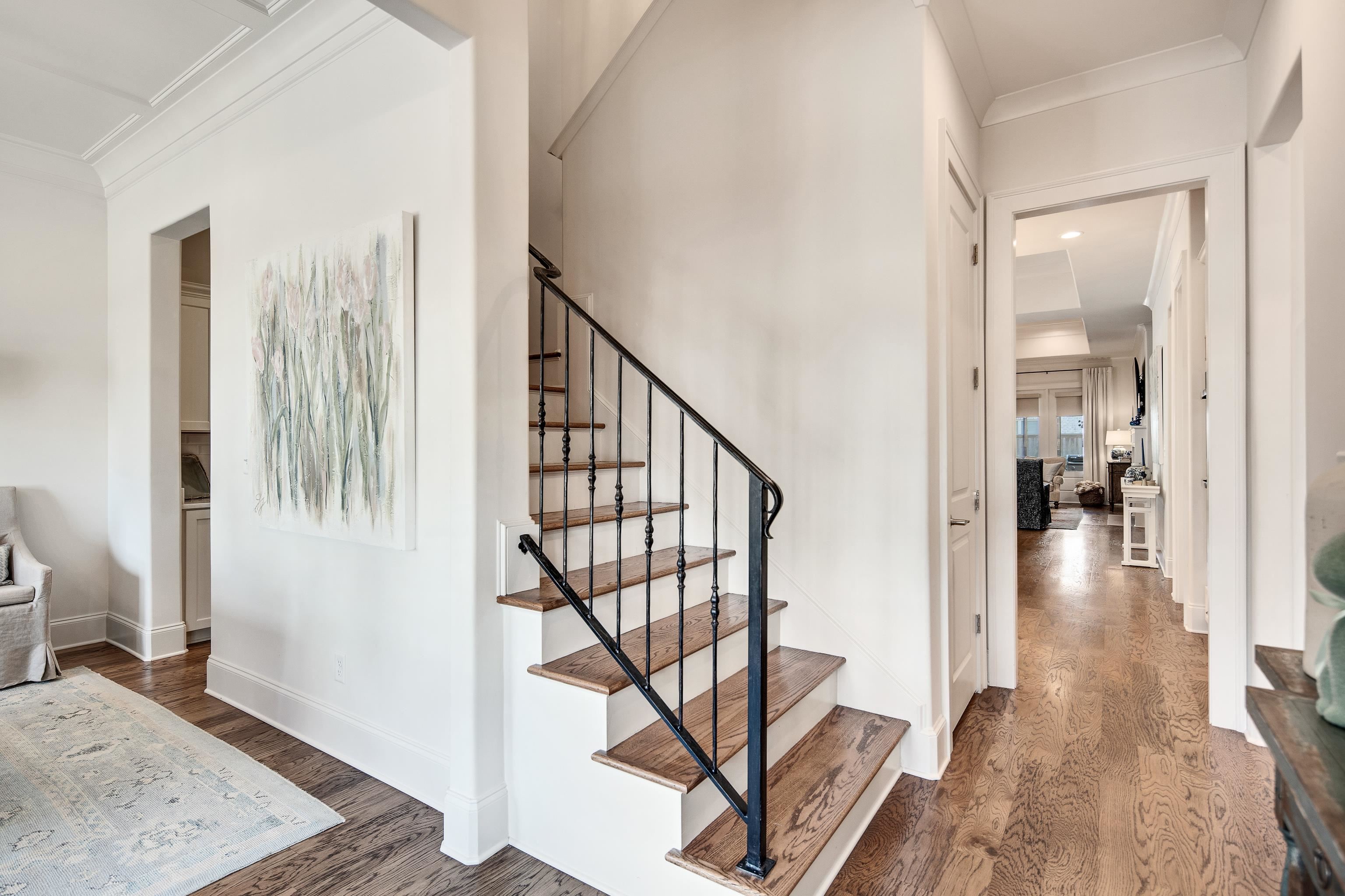 1389 Peyton Parkway Collierville, TN 38017 - Photo 26 of 38 a view of a hallway with wooden floor and stairs