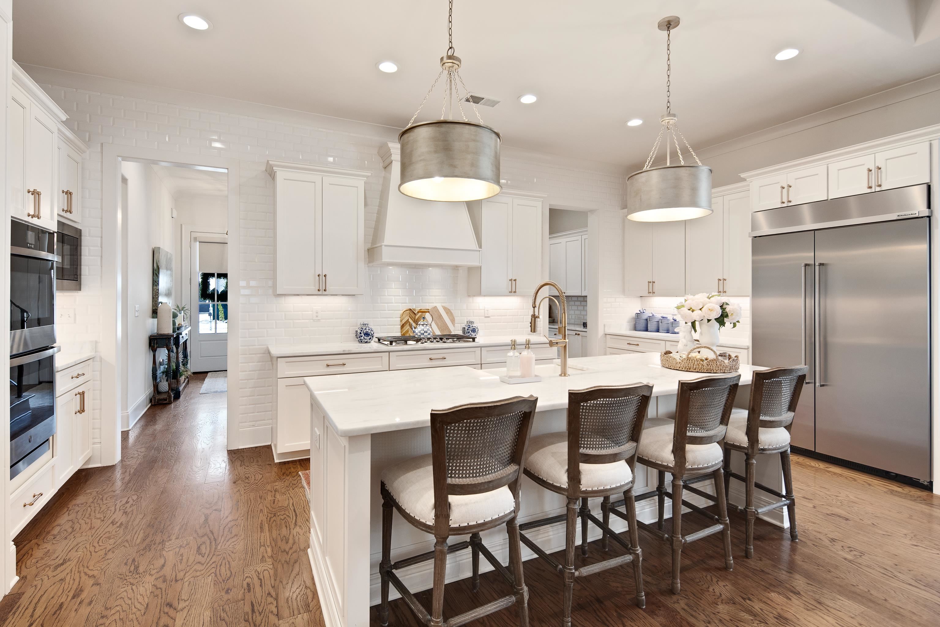1389 Peyton Parkway Collierville, TN 38017 - Photo 5 of 38 a kitchen with kitchen island granite countertop a sink and a refrigerator