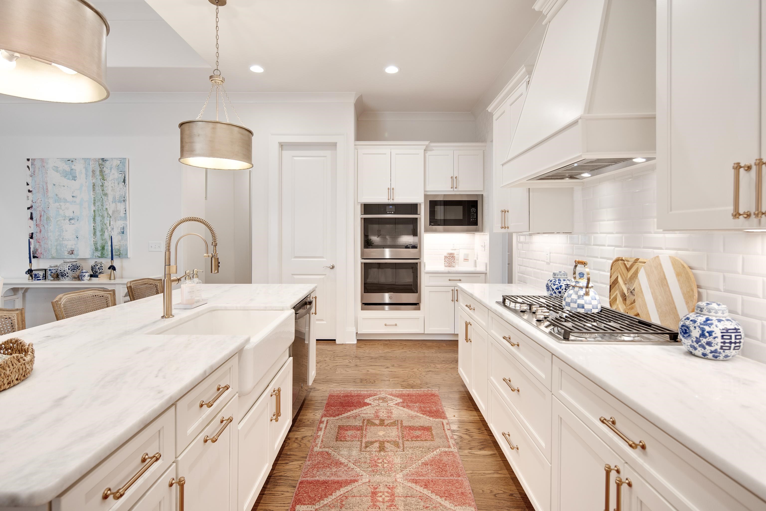 1389 Peyton Parkway Collierville, TN 38017 - Photo 7 of 38 a kitchen with stainless steel appliances kitchen island granite countertop a sink and cabinets