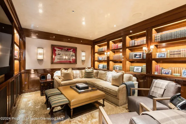 a bedroom with furniture and a large window