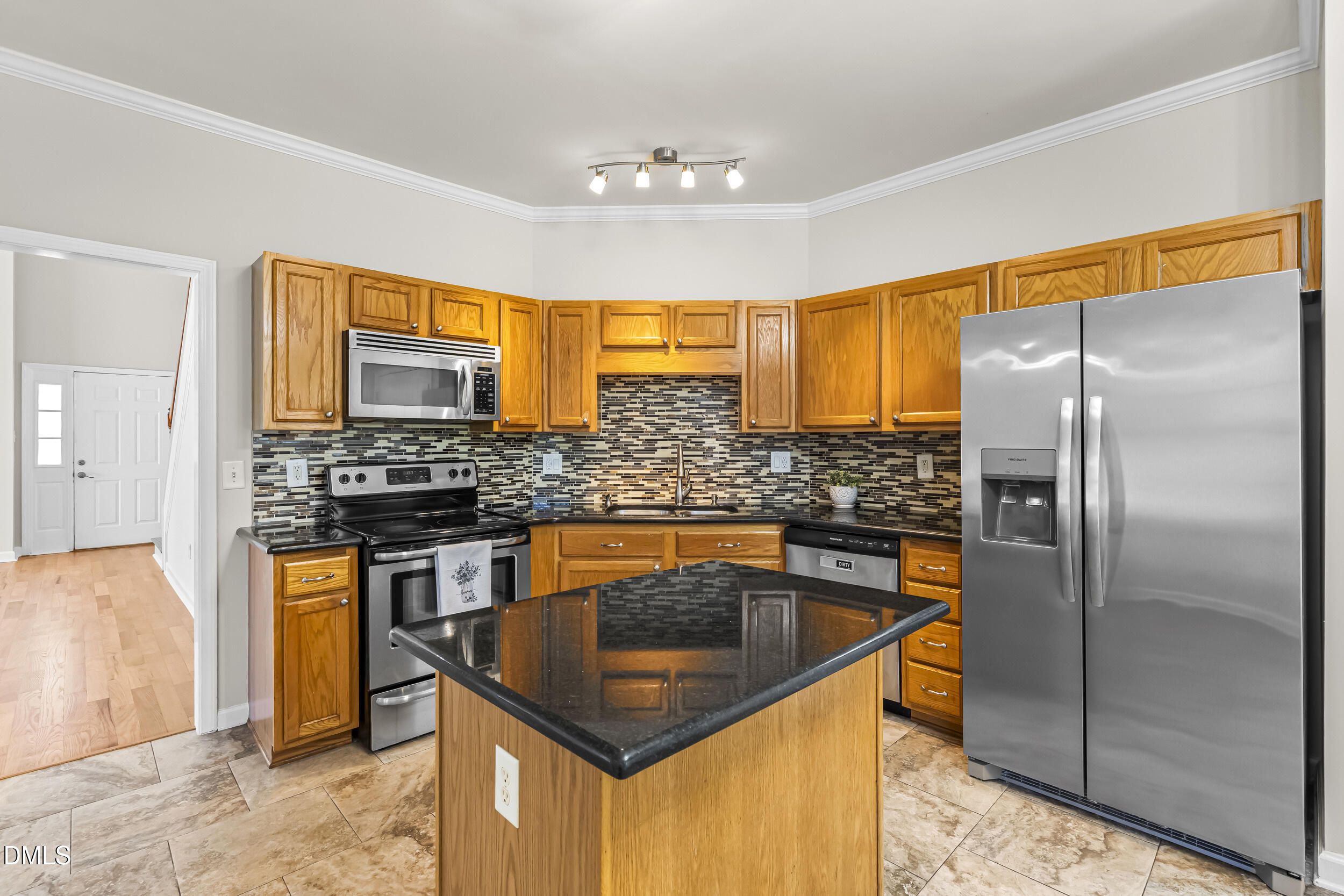 4809 Elmhurst Ridge Court Raleigh, NC 27616 - Photo 13 of 46 a kitchen with stainless steel appliances granite countertop a sink stove and refrigerator