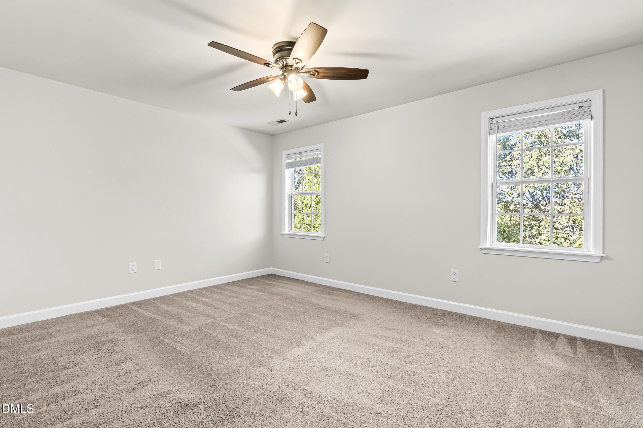 4809 Elmhurst Ridge Court Raleigh, NC 27616 - Photo 23 of 46 an empty room with windows and fan
