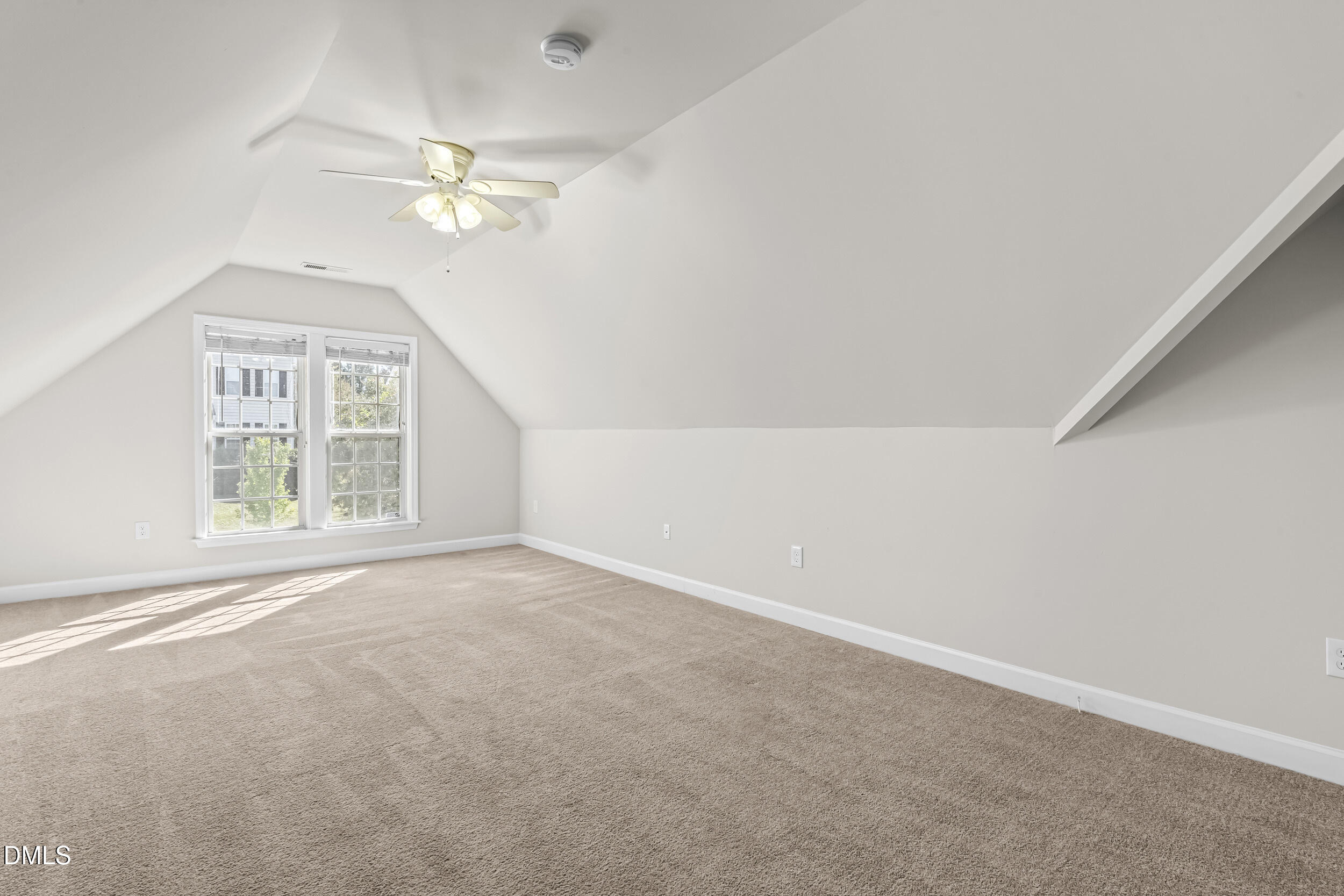 4809 Elmhurst Ridge Court Raleigh, NC 27616 - Photo 25 of 46 an empty room with windows and chandelier fan