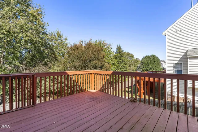 a balcony with wooden floor and fence