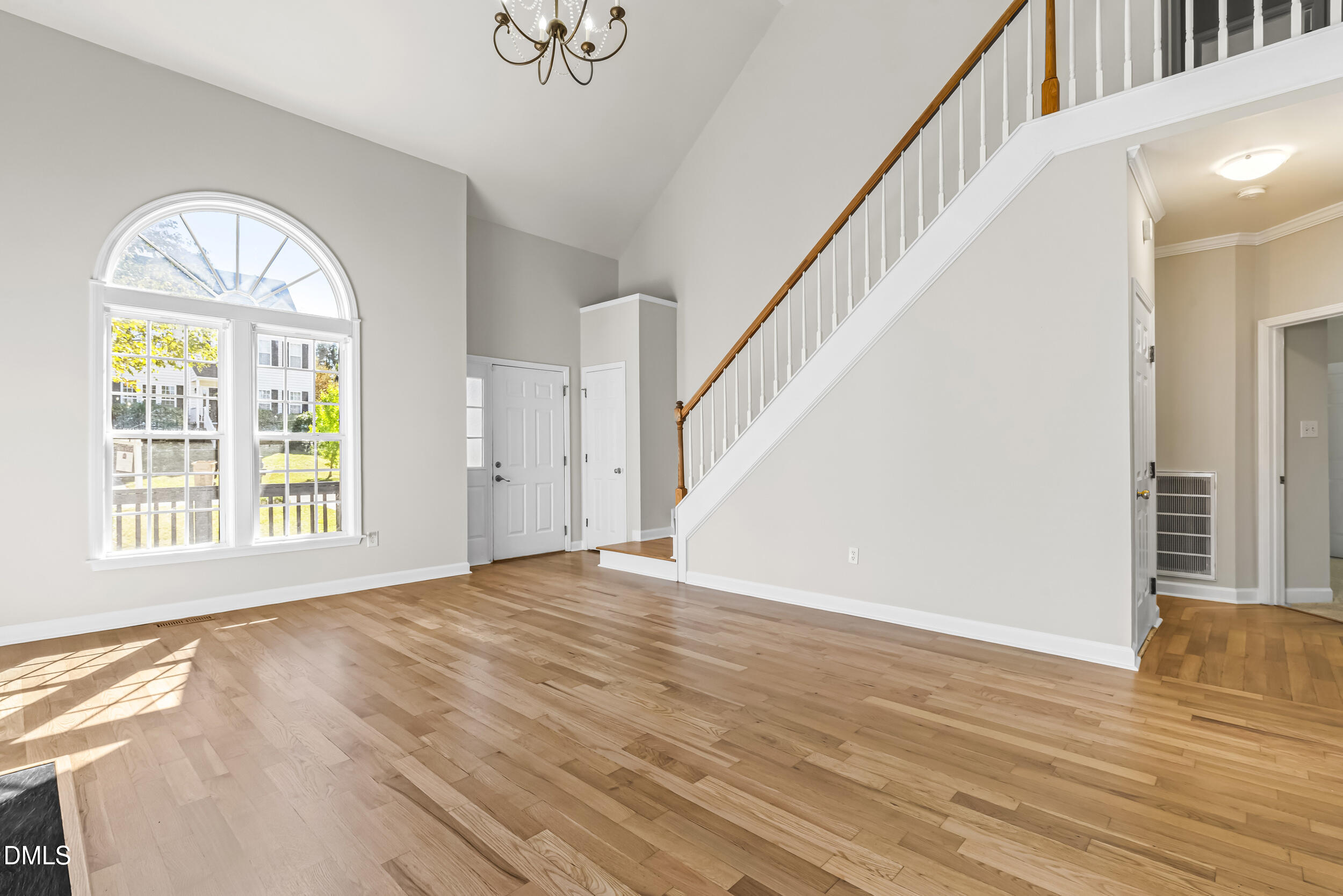 4809 Elmhurst Ridge Court Raleigh, NC 27616 - Photo 4 of 46 a view of an empty room with wooden floor and a window
