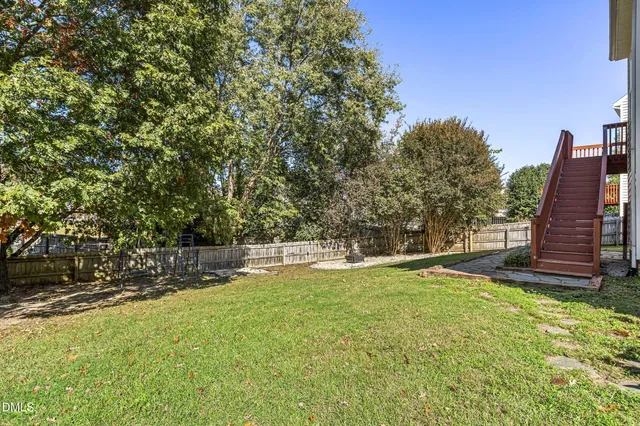 a view of a backyard with a large tree