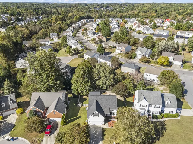an aerial view of a house with a yard