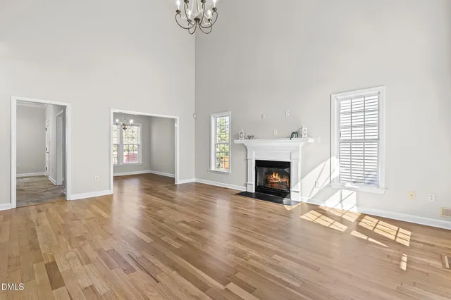 a view of a livingroom with wooden floor and a fireplace