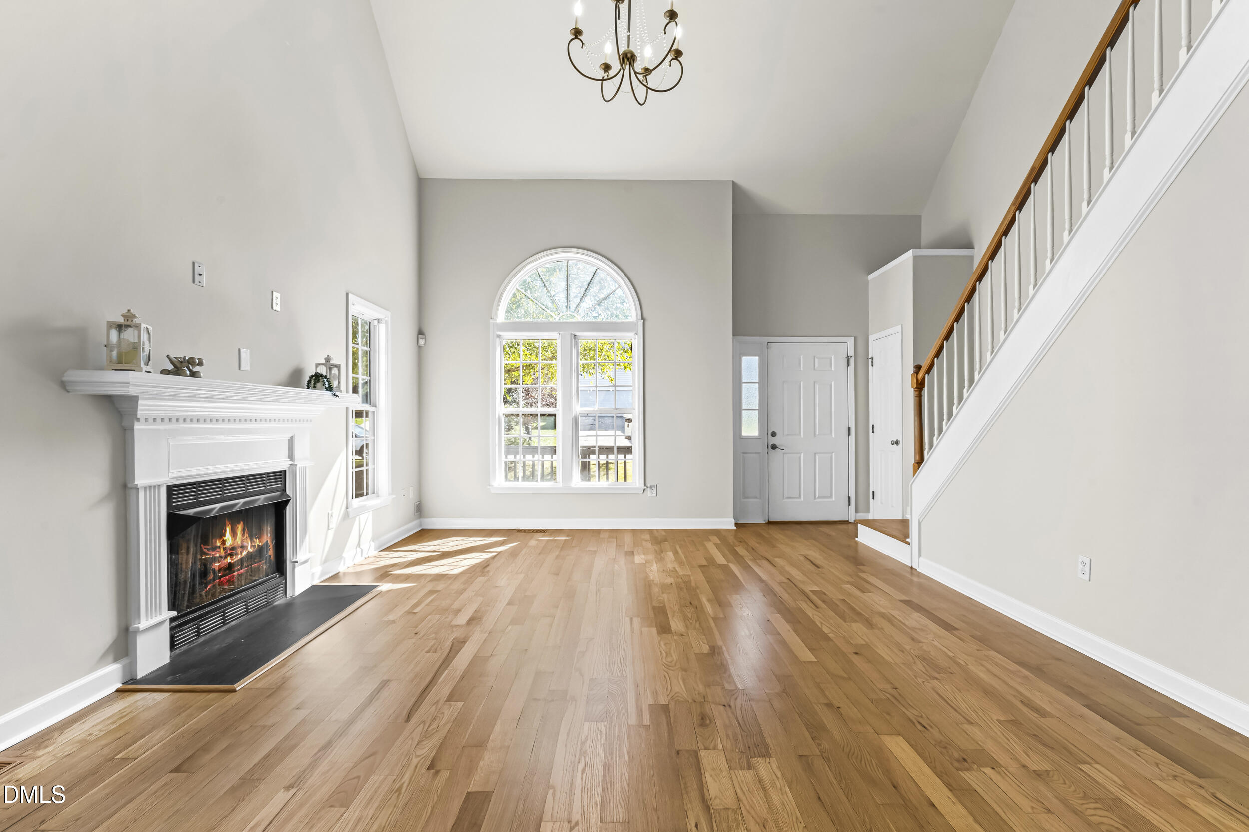 4809 Elmhurst Ridge Court Raleigh, NC 27616 - Photo 7 of 46 a view of an empty room with wooden floor fireplace and a window