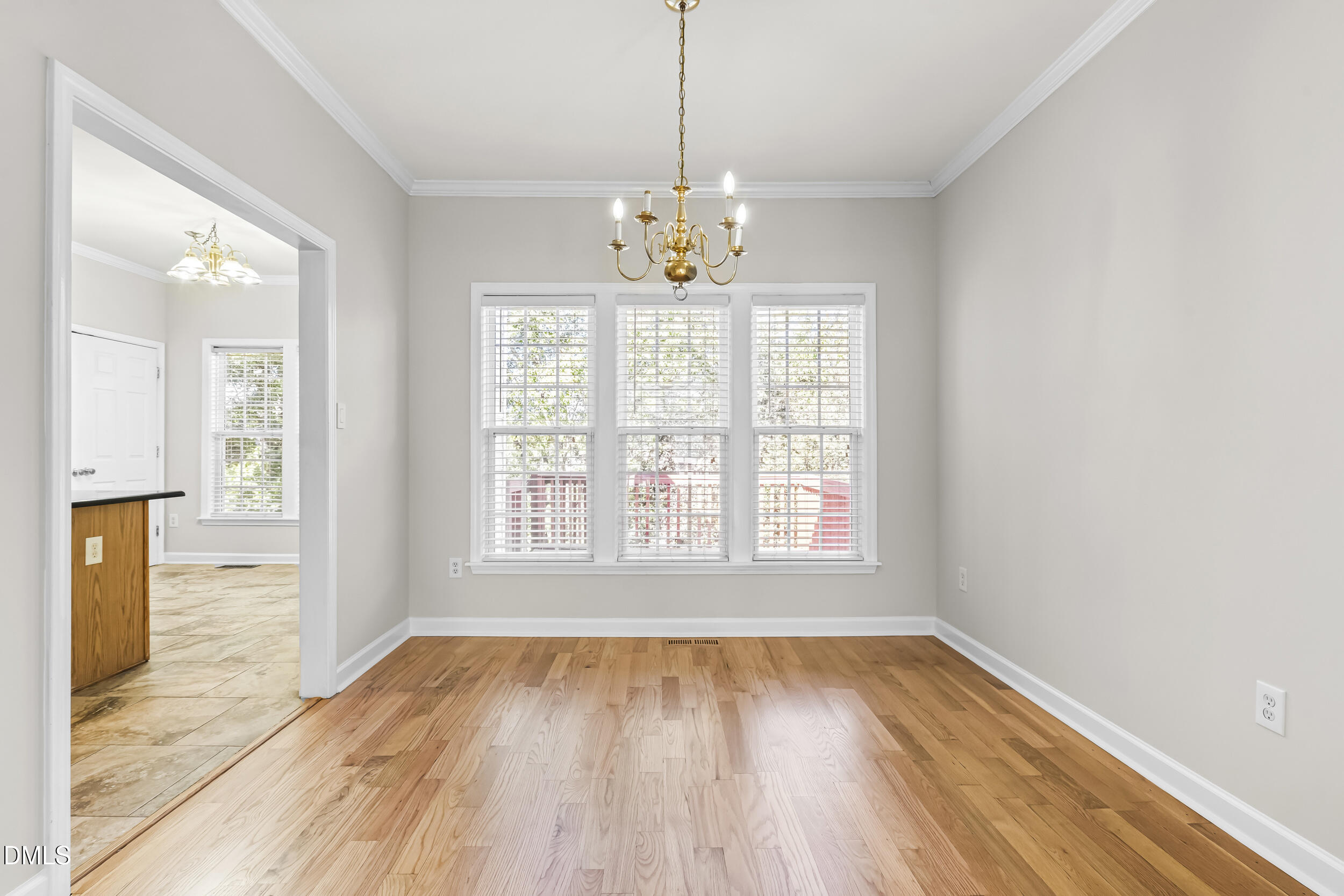 4809 Elmhurst Ridge Court Raleigh, NC 27616 - Photo 10 of 46 a view of an empty room with wooden floor and a window