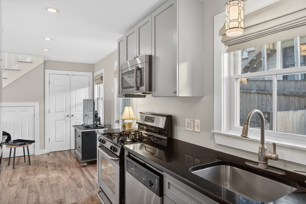 16 Conwell Street, Unit 3 Provincetown, MA 02657 - Photo 13 of 41 a kitchen with stainless steel appliances granite countertop a sink stove and refrigerator