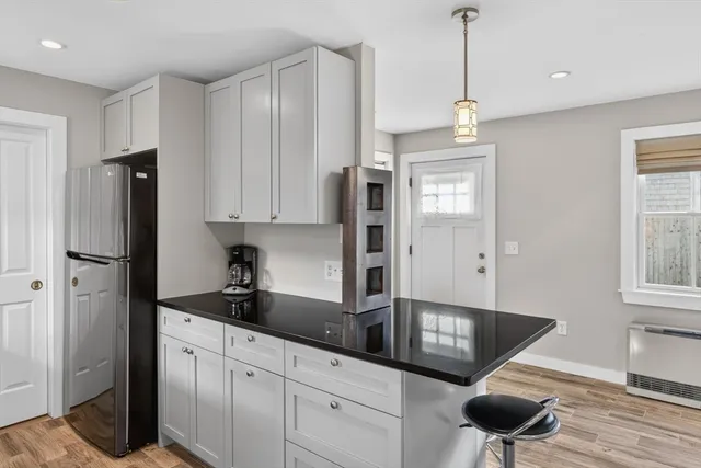 a kitchen with stainless steel appliances granite countertop a refrigerator a sink and a stove