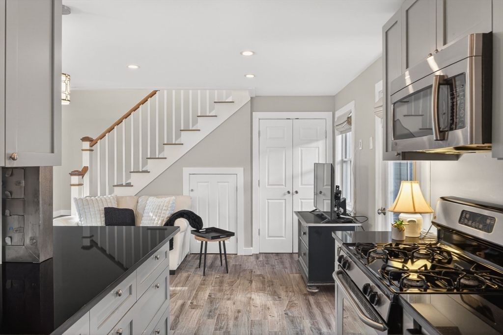 16 Conwell Street, Unit 3 Provincetown, MA 02657 - Photo 17 of 41 a kitchen with a stove a sink and a refrigerator