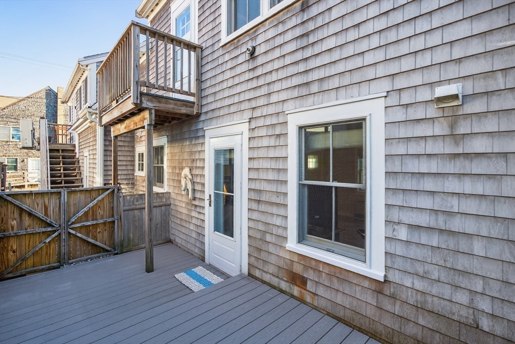 16 Conwell Street, Unit 3 Provincetown, MA 02657 - Photo 22 of 41 a view of a porch with wooden floor and stairs