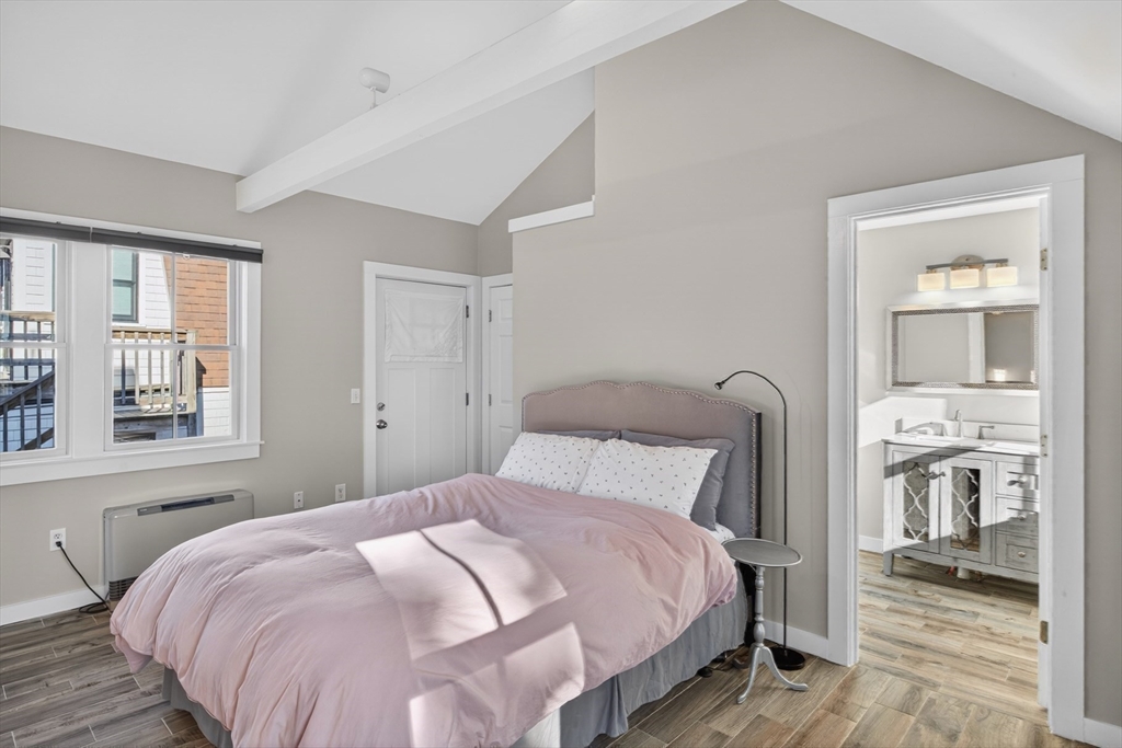 16 Conwell Street, Unit 3 Provincetown, MA 02657 - Photo 27 of 41 a bedroom with a bed and wooden floor