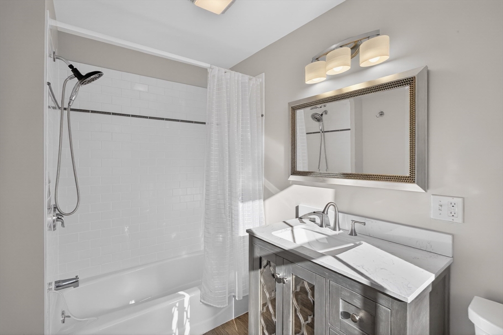 16 Conwell Street, Unit 3 Provincetown, MA 02657 - Photo 30 of 41 a bathroom with a sink toilet a mirror and shower