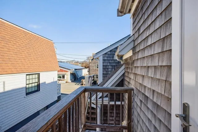 a view of balcony with two chairs and wooden floor