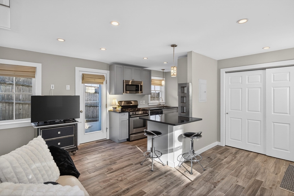 16 Conwell Street, Unit 3 Provincetown, MA 02657 - Photo 7 of 41 a living room with furniture and a flat screen tv