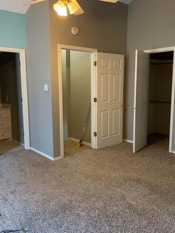 an empty room with closet and a bathroom
