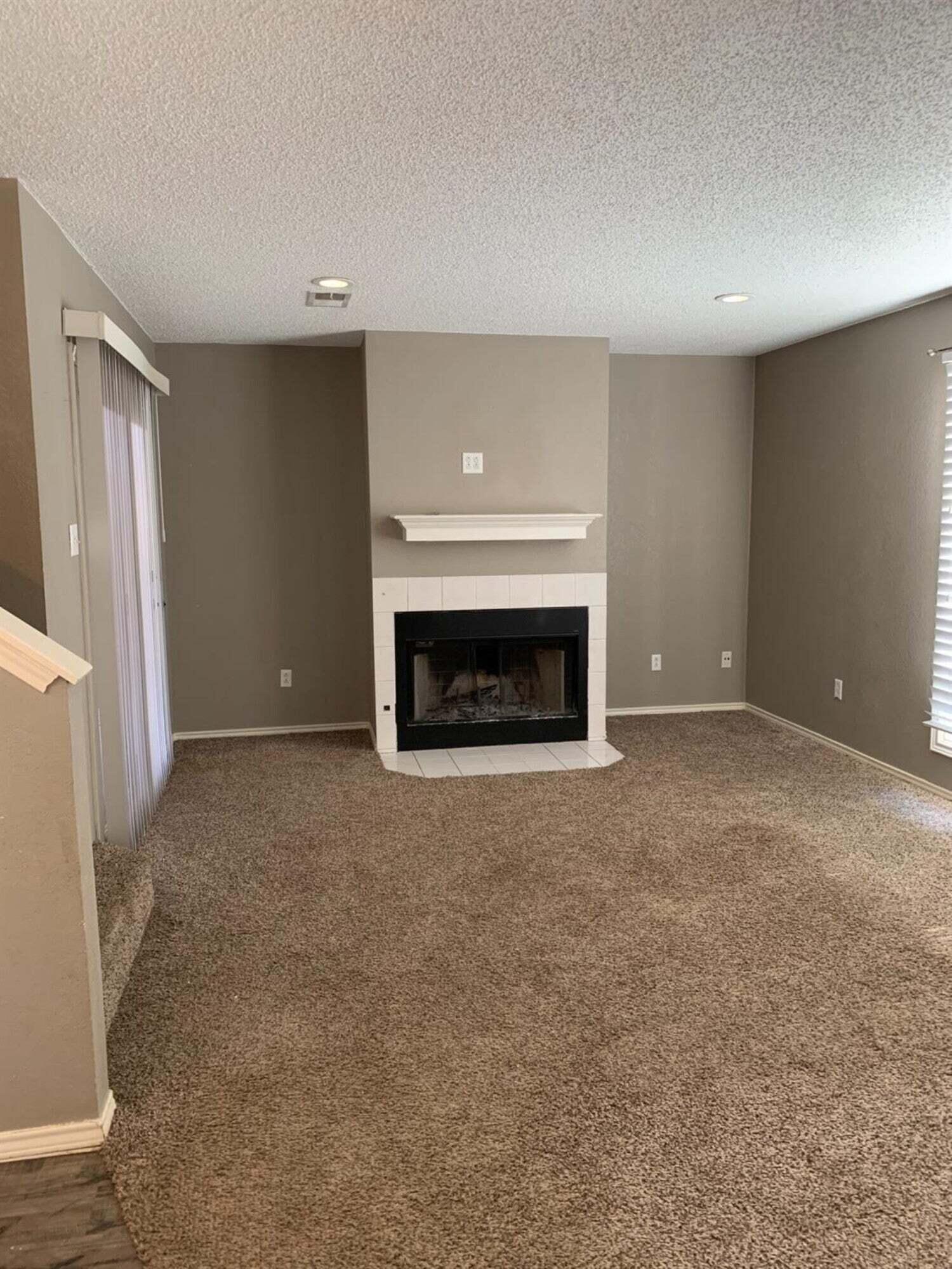 8308 Raleigh Avenue, Unit A Lubbock, TX 79424 - Photo 2 of 14 a view of empty room with a fireplace
