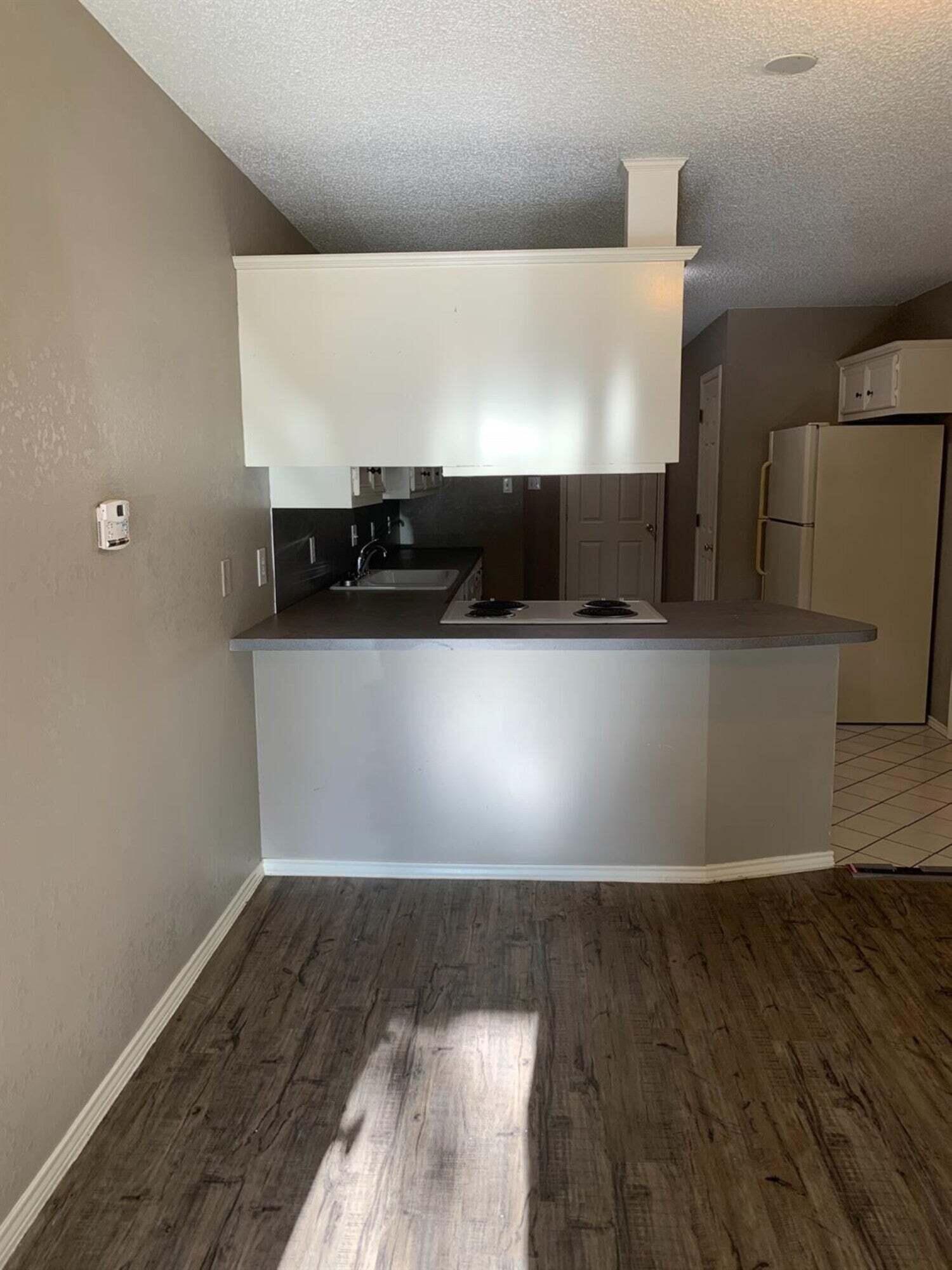 8308 Raleigh Avenue, Unit A Lubbock, TX 79424 - Photo 3 of 14 a view of an empty room with wooden floor