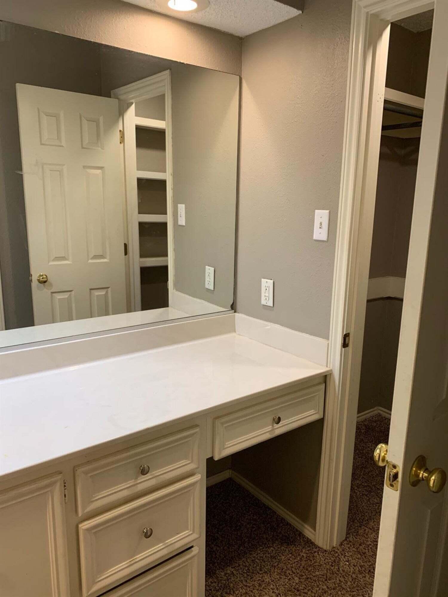 8308 Raleigh Avenue, Unit A Lubbock, TX 79424 - Photo 7 of 14 a room with a cabinets and a dresser