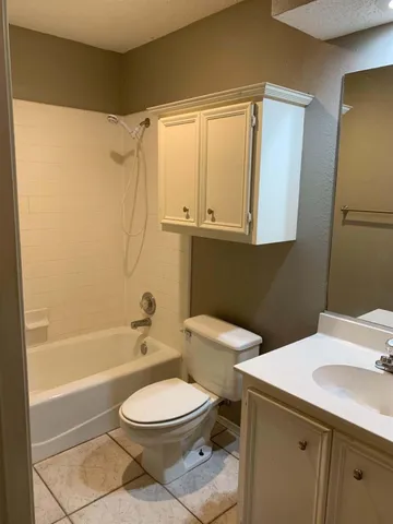 a bathroom with a toilet a sink and bathtub