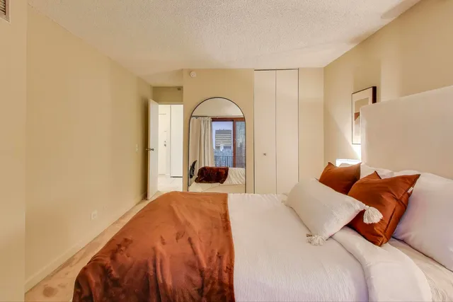 a bedroom with a bed and a large window