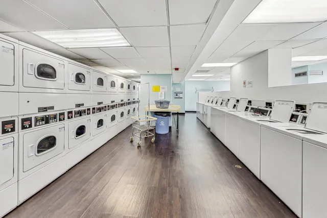 a kitchen with stainless steel appliances granite countertop a stove and a wooden floors