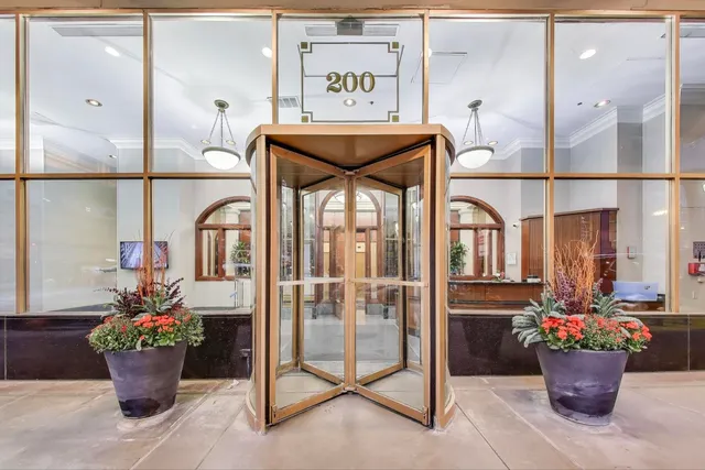a dining room with furniture and a potted plant