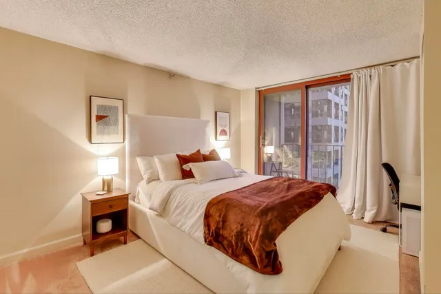 a bedroom with a bed and a window