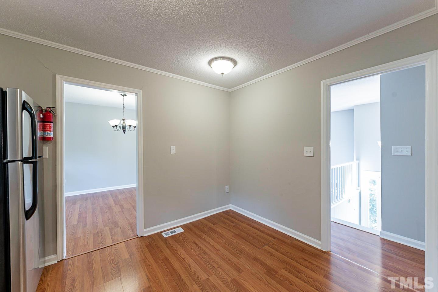 3601 Dixon Road Durham, NC 27707 - Photo 12 of 27 wooden floor in an empty room with a mirror
