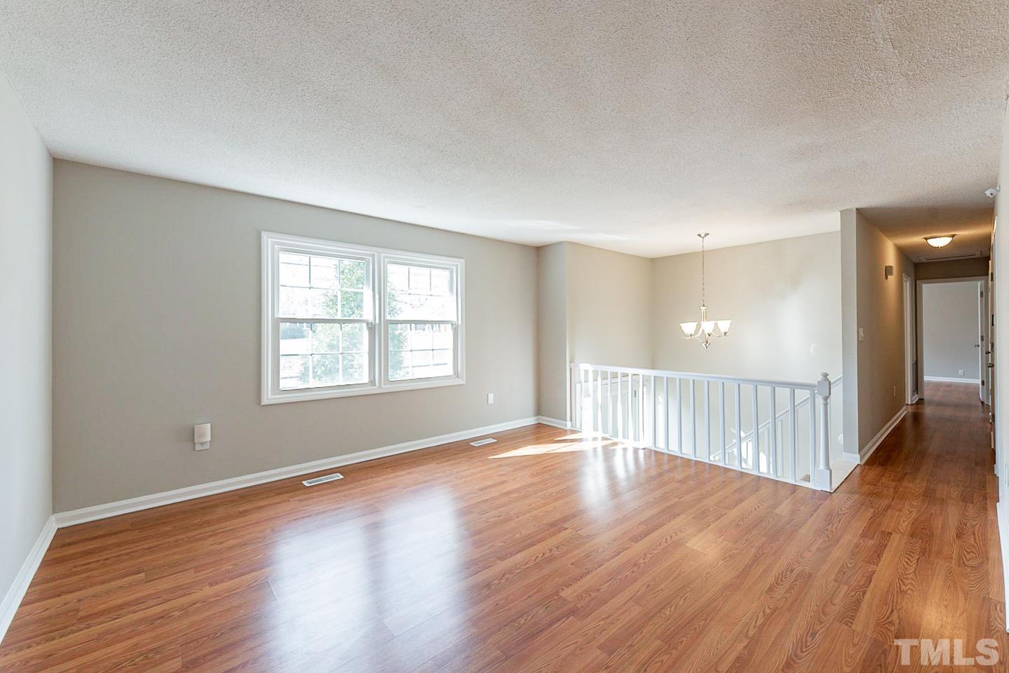 3601 Dixon Road Durham, NC 27707 - Photo 13 of 27 a view of an empty room with wooden floor and a window