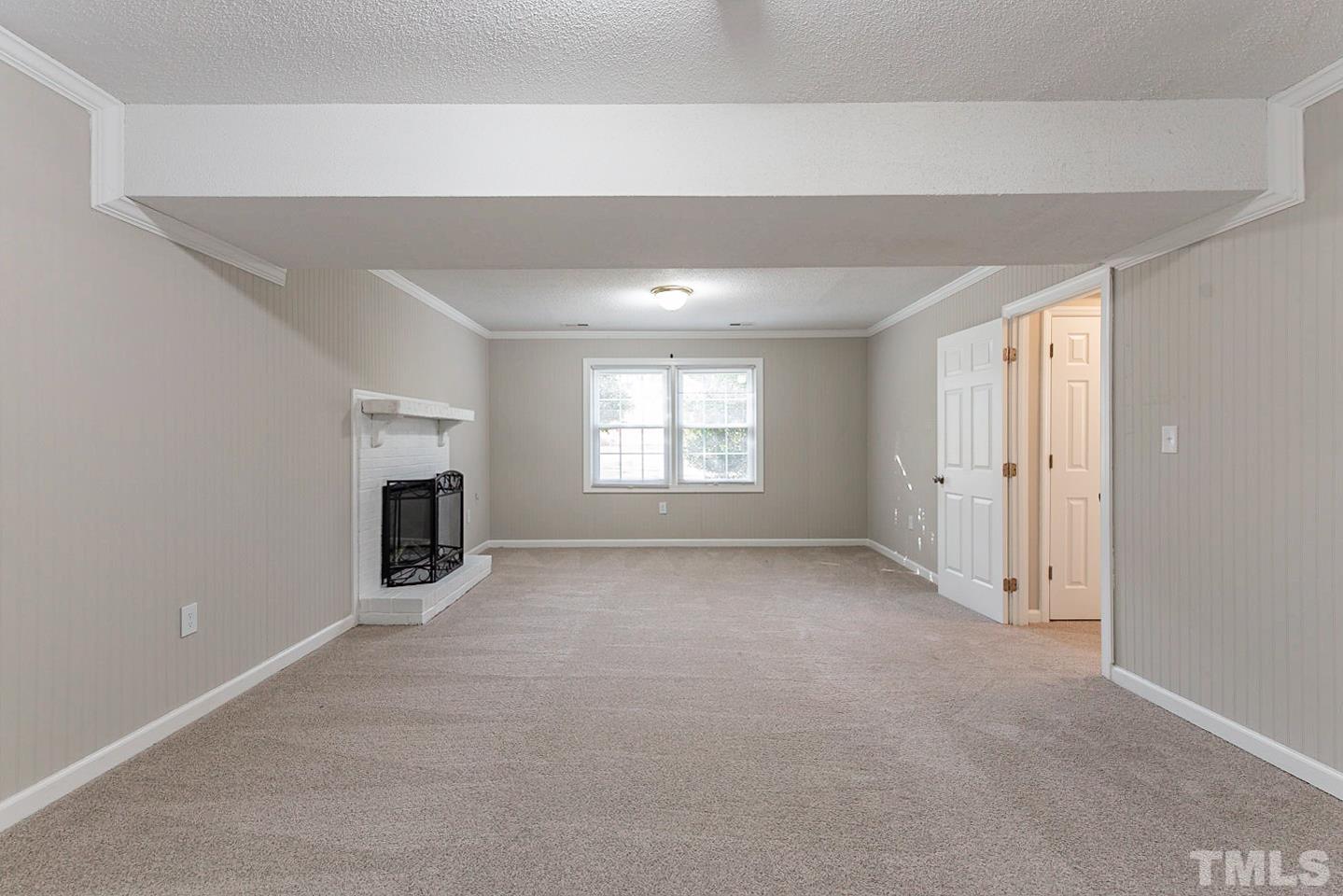 3601 Dixon Road Durham, NC 27707 - Photo 17 of 27 an empty room with fireplace and windows