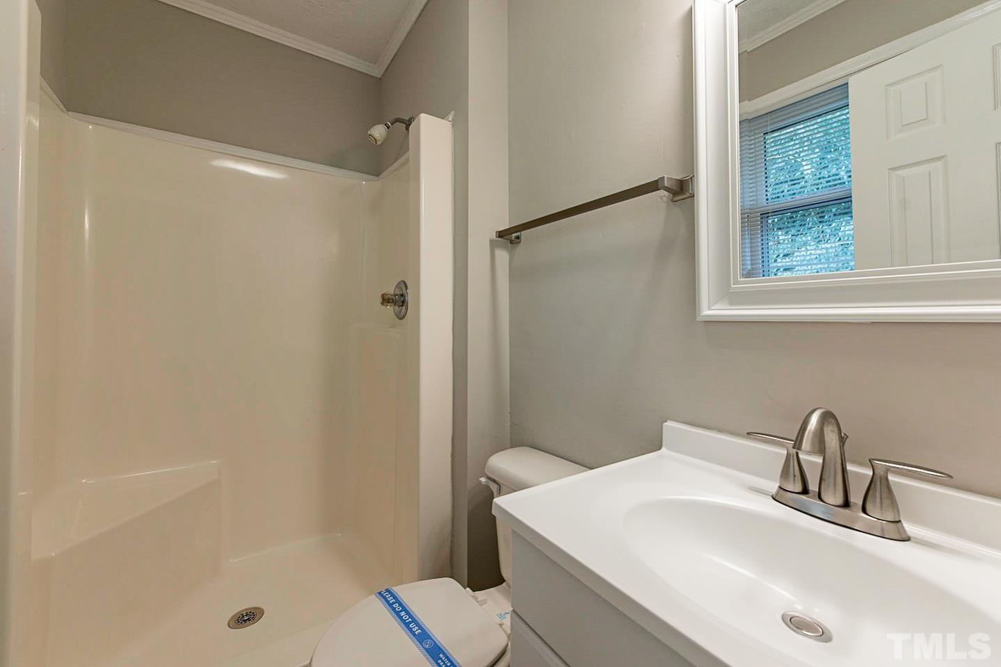 3601 Dixon Road Durham, NC 27707 - Photo 21 of 27 a bathroom with a sink and a mirror